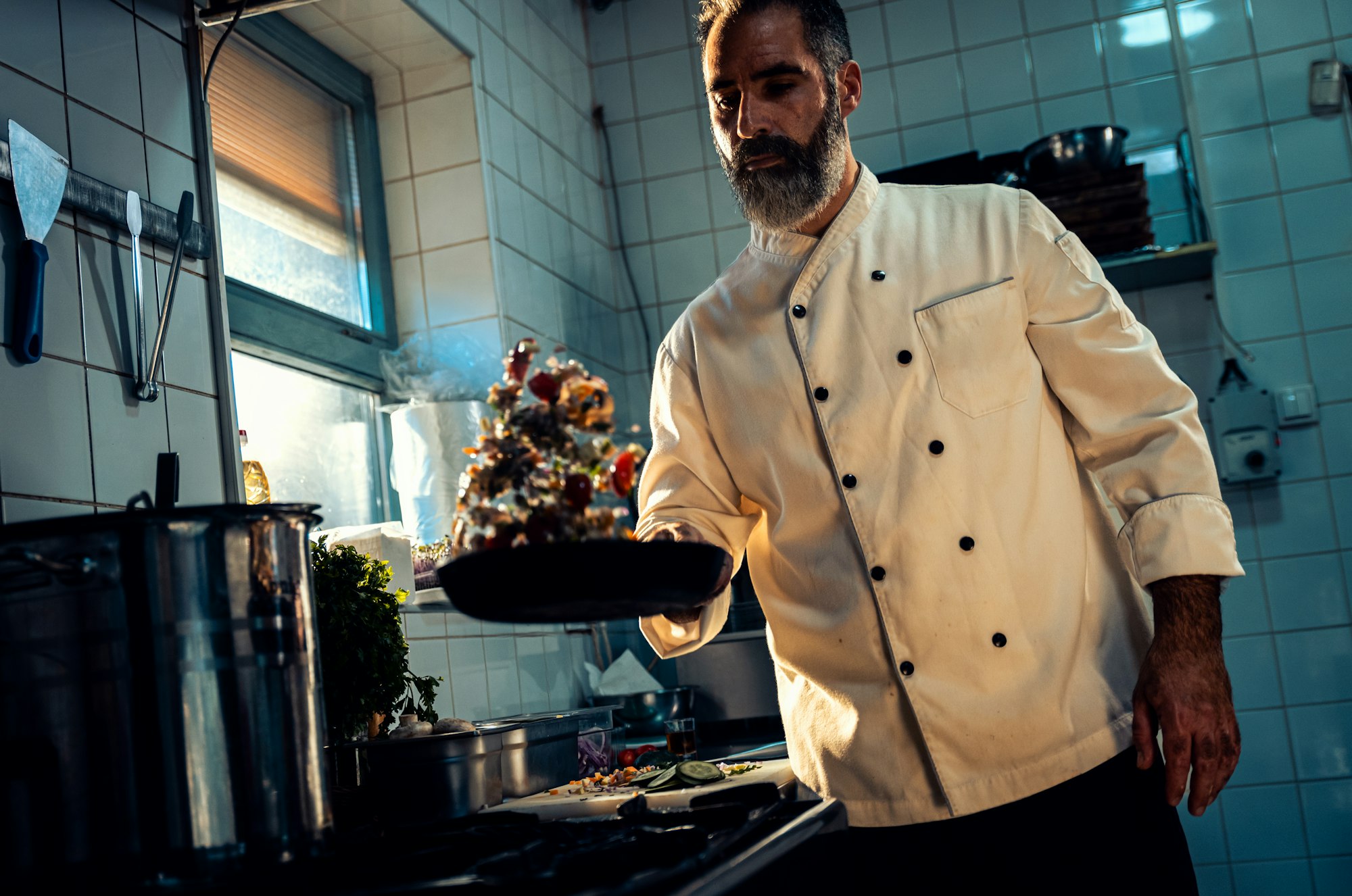 Chef cooking in a commercial kitchen.